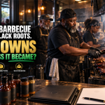 Black Memphis pitmaster tending barbecue ribs inside a multigenerational restaurant, with sauce bottles, shipping boxes and business documents representing ownership, distribution and succession.
