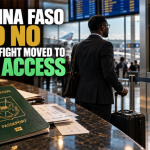 Burkinabè passport and West African business traveler facing a closed U.S. visa checkpoint, illustrating sovereignty, visa restrictions, and economic access.